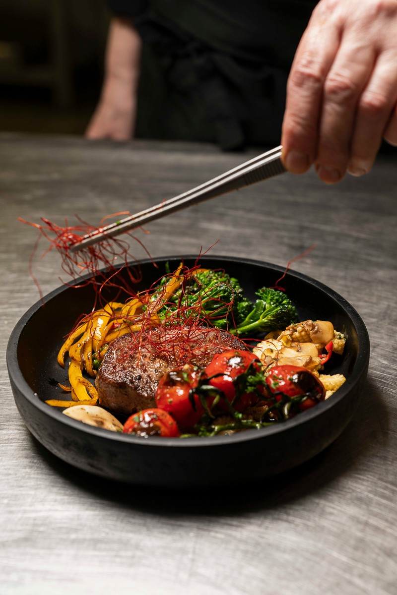EGS Koch richtet ein Steak mit der Pinzette an — Fine Dining aus eigener Produktion